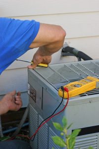 central ac system being worked on by a technician