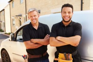 smiling-HVAC-technicians-with-truck