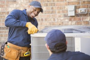 smiling-HVAC-technician-doing-repairs